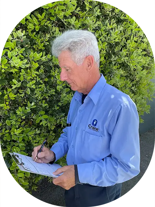 Crane Pest Control worker writing on clipboard